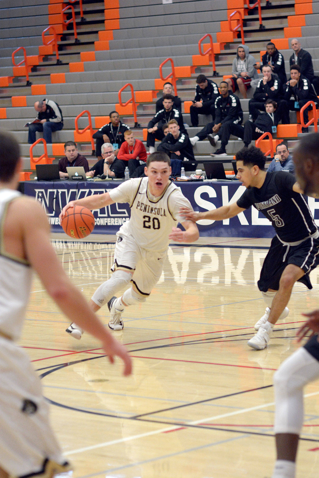 Rick Ross/Peninsula College                                Peninsula’s Cole Rabedeaux, left, drives against Portland’s Joe Morales during the Pirates’ 70-62 win in the opening round of the NWAC Men’s Basketball Tournament on Thursday at Everett Community College.