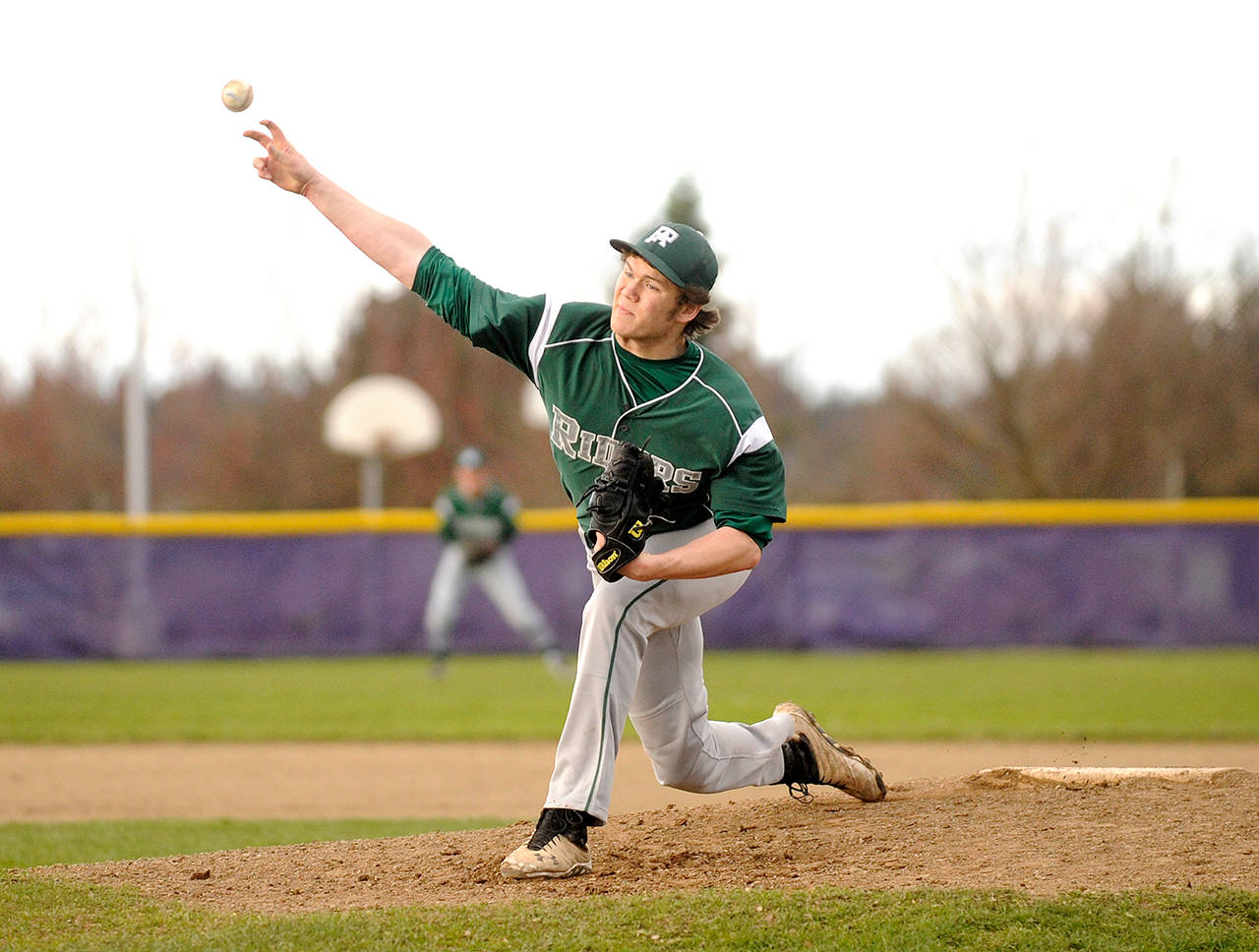 Michael Dashiell/Olympic Peninsula News Group Port Angeles’ Dane Bradow lets fly with a pitch during the Roughriders’ win over Sequim last week.