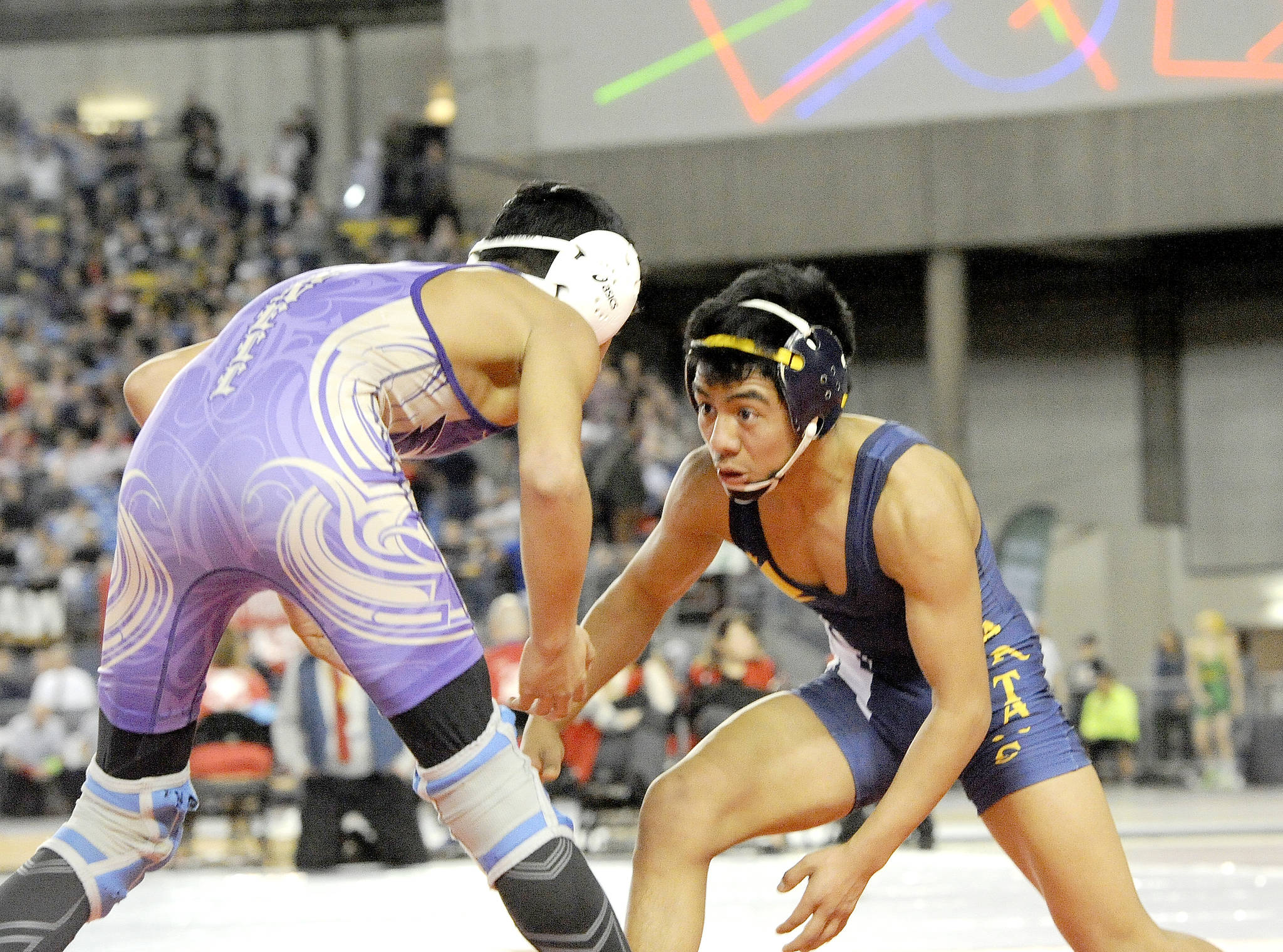 Lonnie Archibald/for Peninsula Daily News                                Forks’ Josue Lucas, right, was the lone state champion from the North Olympic Peninsula at Mat Classic in the Tacoma Dome. Lucas, wrestling as a 106-pounder, went 35-4 on the season with regional and sub-regional titles.