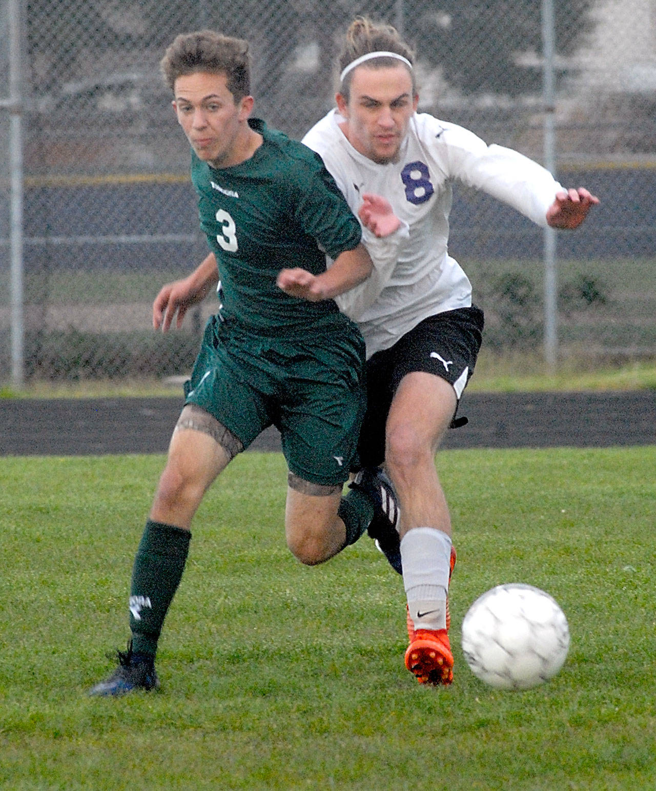 Keith Thorpe/Peninsula Daily News                                Port Angeles’ Andrew St. George, left, and Sequim’s Liam Harris battle for control in Friday night’s match at Sequim High School.