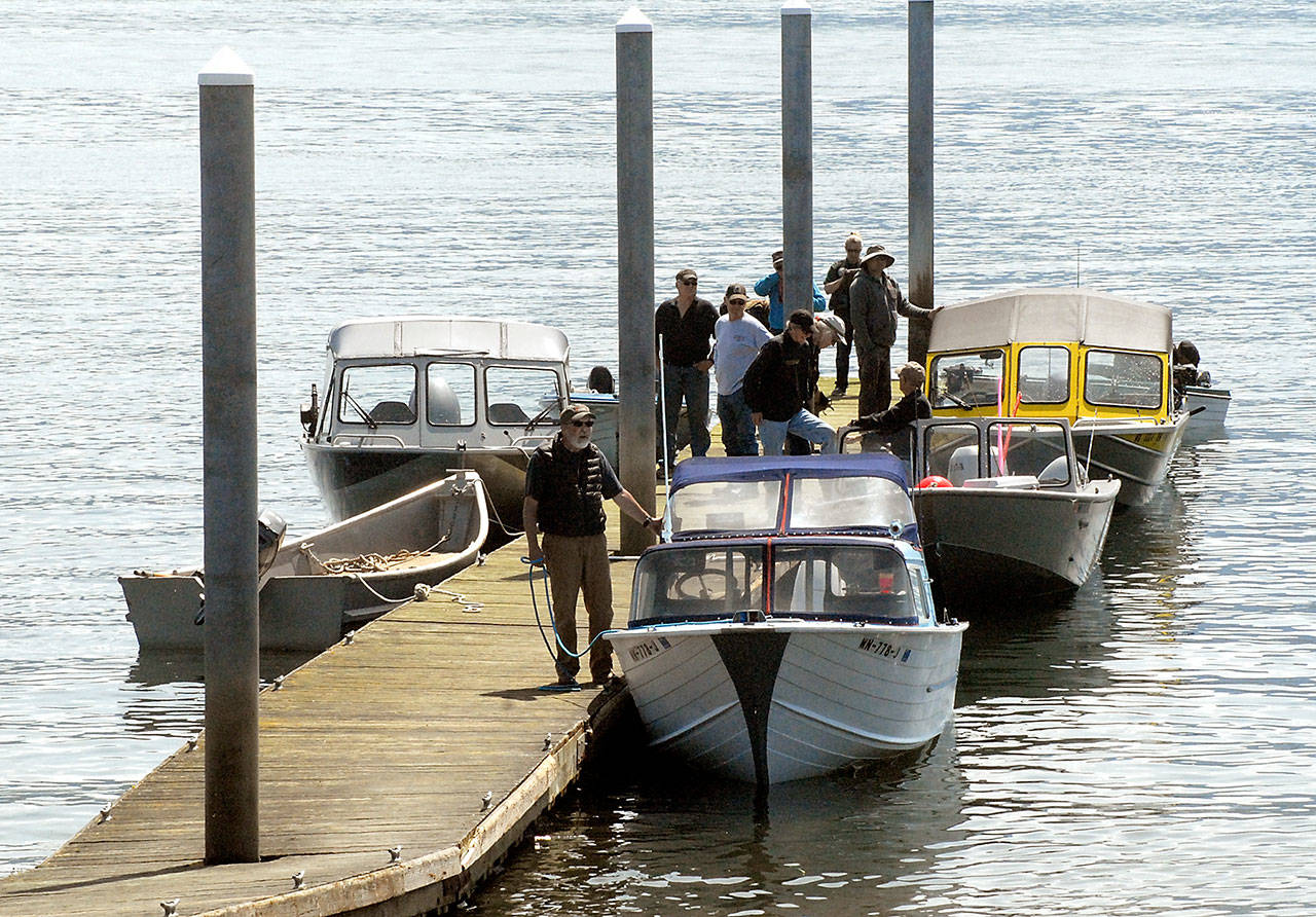 Keith Thorpe/Peninsula Daily News                                Halibut anglers line up at one of two docks on Ediz Hook in Port Angeles waiting to be hauled out on Thursday.