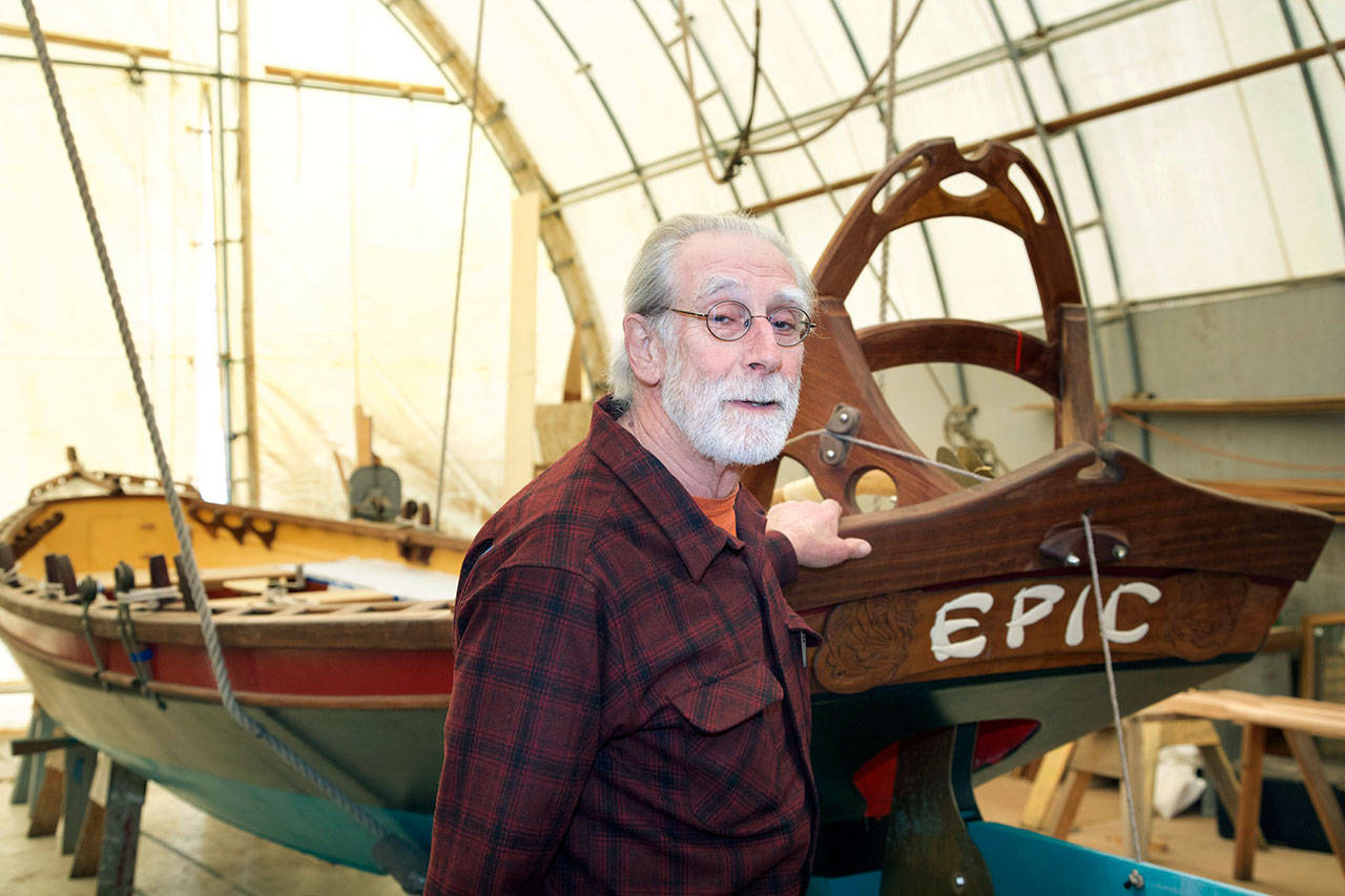 Henry Hazen, a 2017 Heart of Service Award recipient, stands by the 30-foot-long boat, EPIC, that he helped construct by mentoring students at Community Boat Project in Port Hadlock. (Steve Mullensky/for Peninsula Daily News)