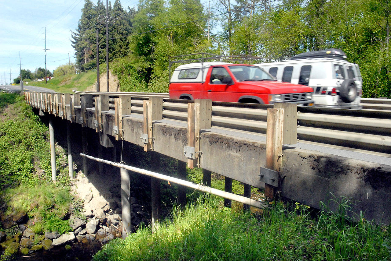 Traffic crosses the McDonald Creek bridge on Old Olympic Highway near Agnew on Tuesday. (Keith Thorpe/Peninsula Daily News)