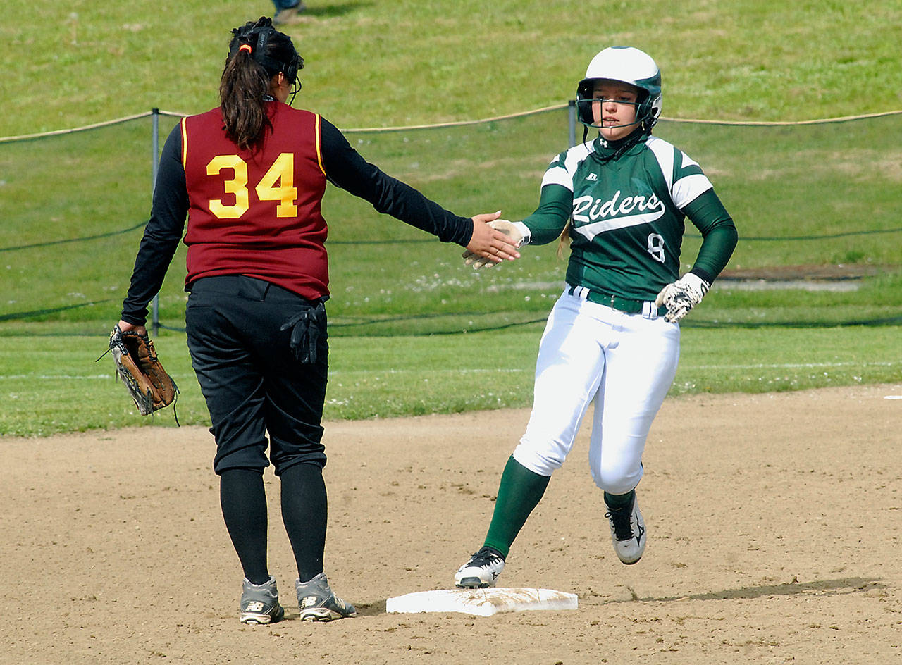 Keith Thorpe/Peninsula Daily News Port Angeles’ Kylee Reid, right, rounds second base is congratulated by Kingston’s Lucy Schaeffer after Reid homered in the first inning during Wednesday’s game at the Dry Creek athletic fields in Port Angeles.