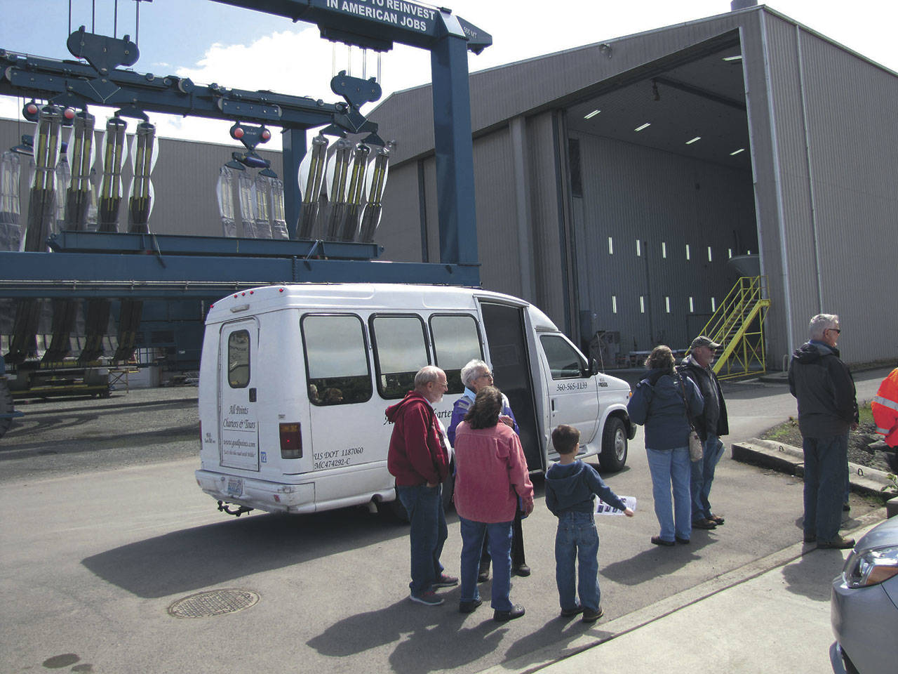 A tour group exits a shuttle bus at Westport Yachts after completing a tour of the Port of Port Angeles marine terminals during Waterfront Day last year. (Peninsula Daily News)