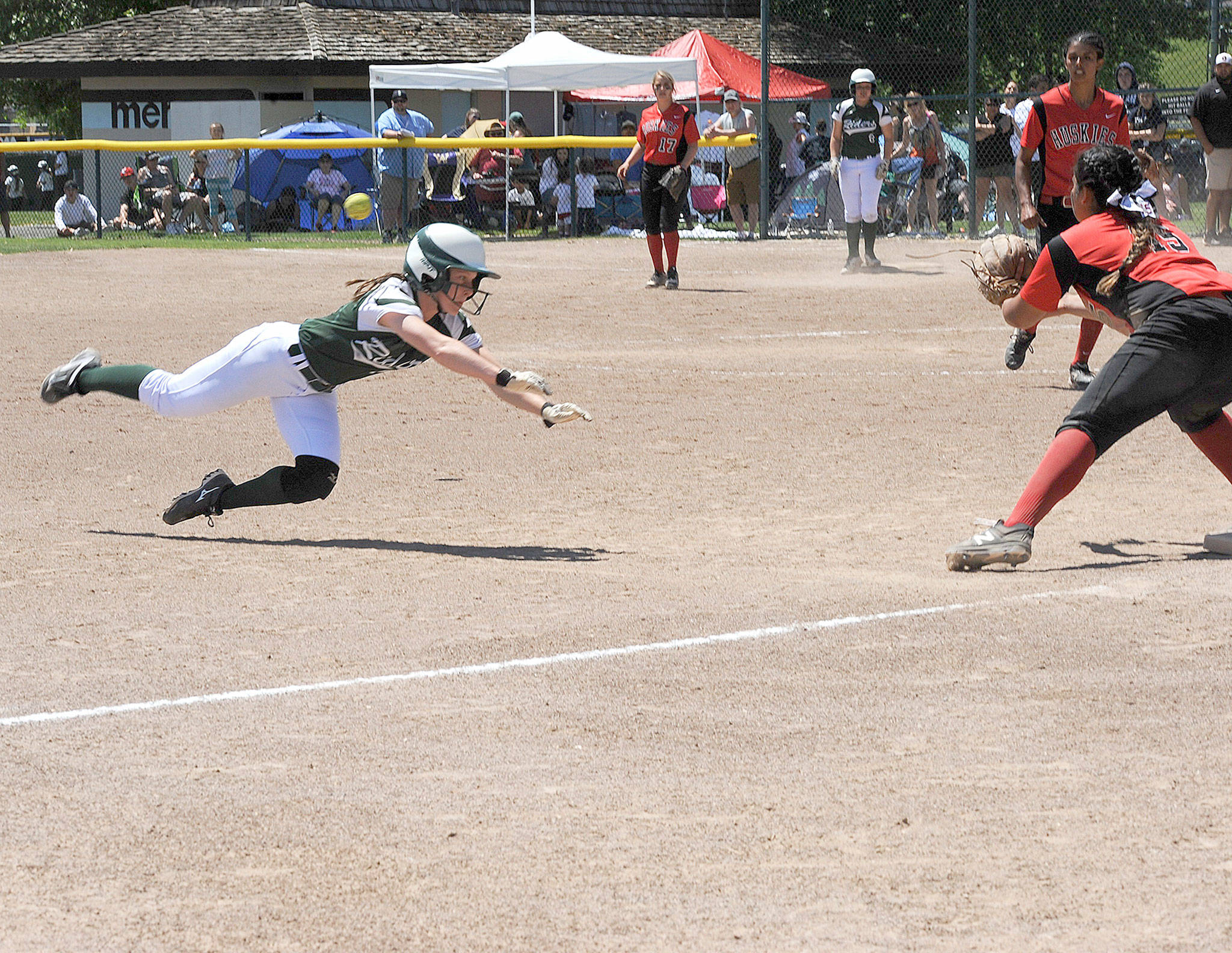 Port Angeles’ Sierra Robinson dives safely into third base as Othello’s Audisey Sauceda covers the base. The Roughriders won the game 1-0 as part of three straight shutouts at the State 2A Softball Tournament. (Lonnie Archibald/for Peninsula Daily News)