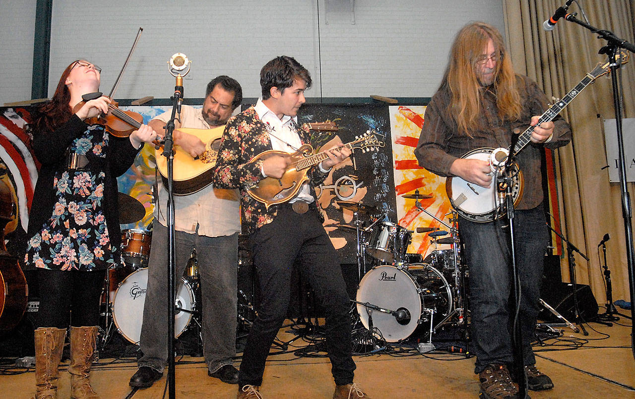 Members of Jeff Scroggins and Colorado, from left, Ellie Hakanson, Greg Blake, Tristan Scroggins and Jeff Scroggins play a set of energized bluegrass on the Main Stage in the Vern Burton Community Center during Friday’s edition of the Juan de Fuca Festival. (Keith Thorpe/Peninsula Daily News)