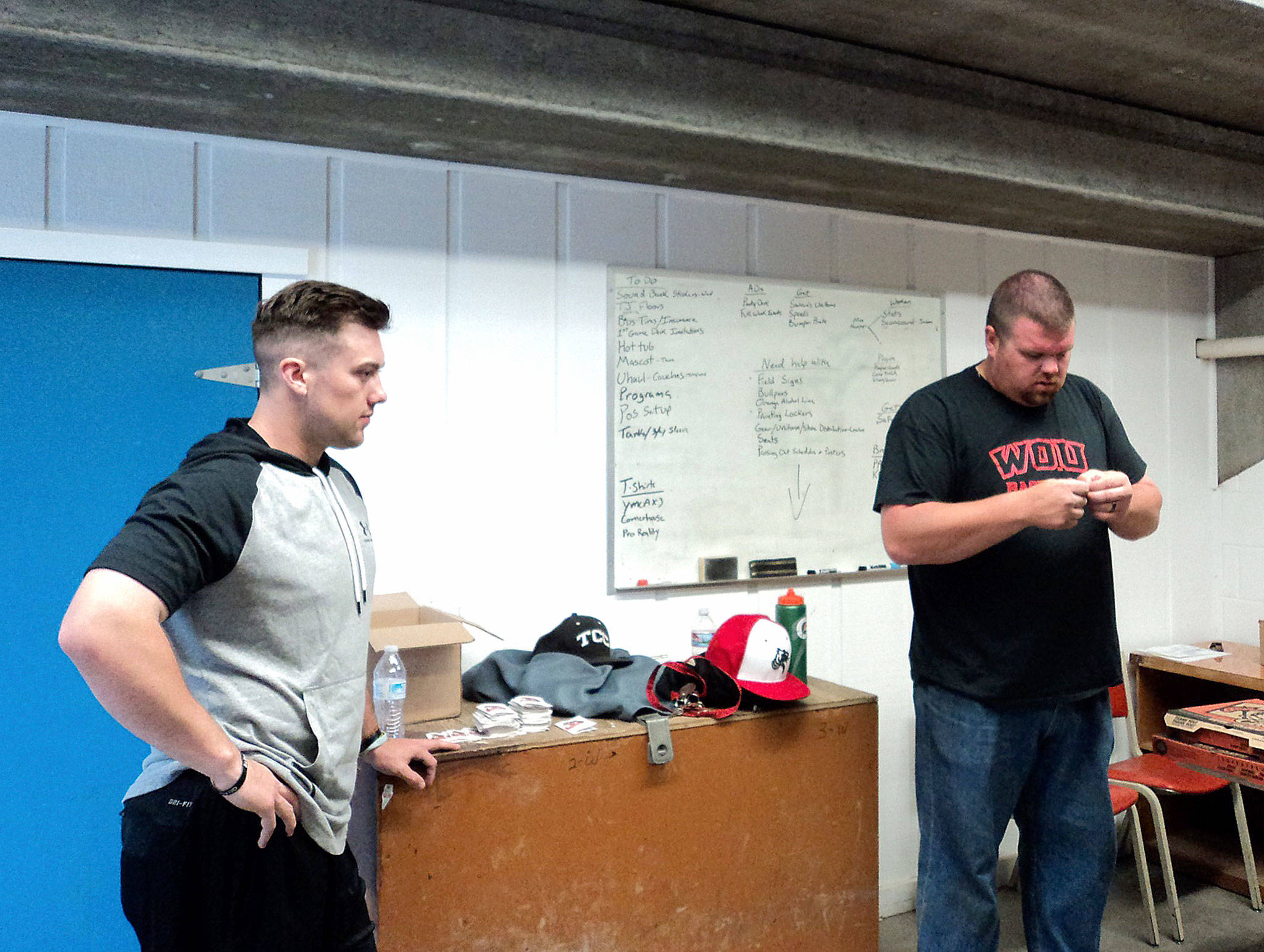 Pierre LaBossiere/for Peninsula Daily News                                Port Angeles Lefties player Joey Galeno, left, chats with manager Zach Miller in the locker room at Civic Field.