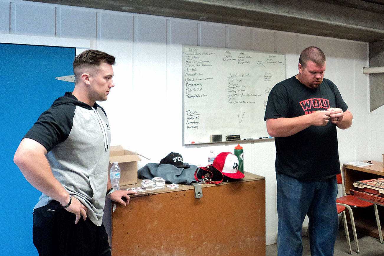 Port Angeles Lefties player Joey Galeno, left, chats with manager Zach Miller in the locker room at Civic Field.                                Pierre LaBossiere/for Peninsula Daily News