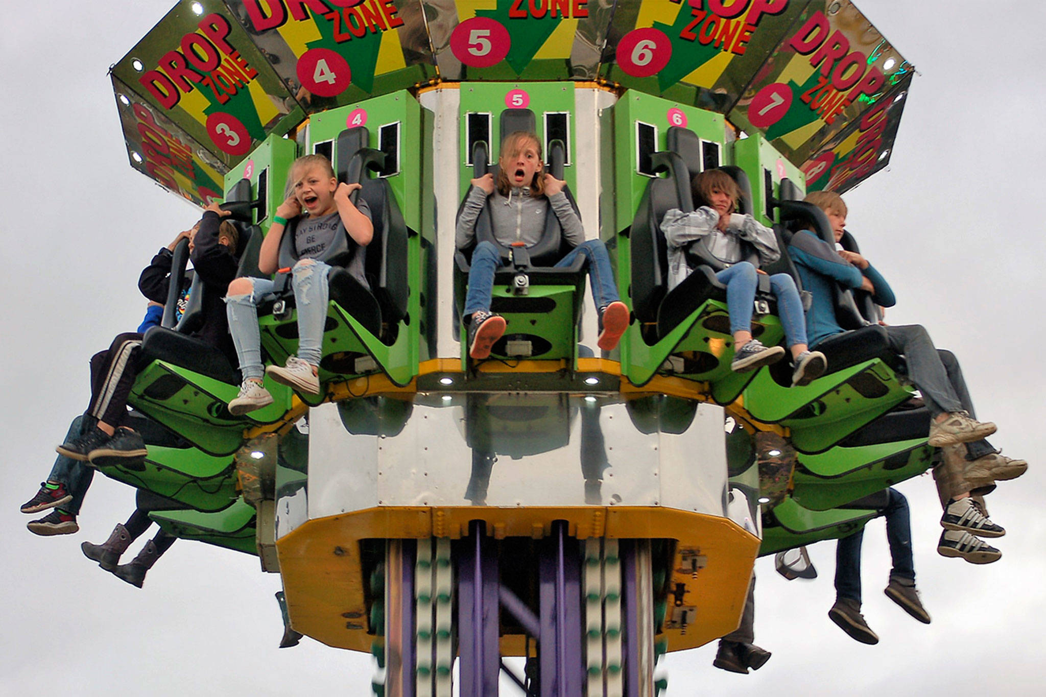 Friends, from left, Emma Swagerty, 12, Natalie Robinson, 10, and Trinity Jones, 11, from Sequim enjoy the last drop on the Drop Zone ride on Saturday night at the Sequim Irrigation Festival’s carnival while celebrating Emma’s birthday. (Matthew Nash/Olympic Peninsula News Group)