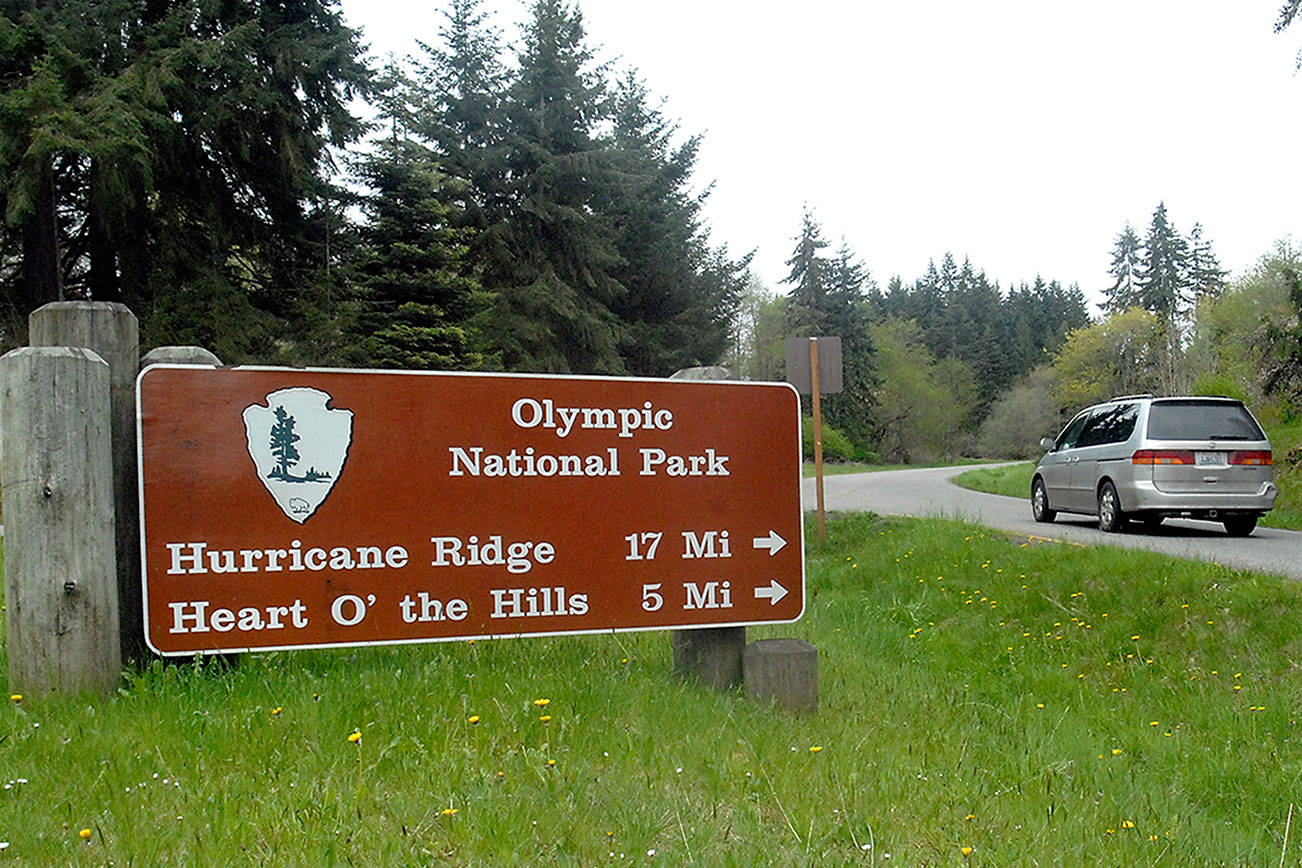 Keith Thorpe/Peninsula Daily News A vehicle makes the turn onto Hurricane Ridge Road towards Heart o’ the Hills and Lake Dawn on Tuesday in Port Angeles. Olympic National Park officials hope to have the road to Hurricane Ridge open on weekends beginning Friday.