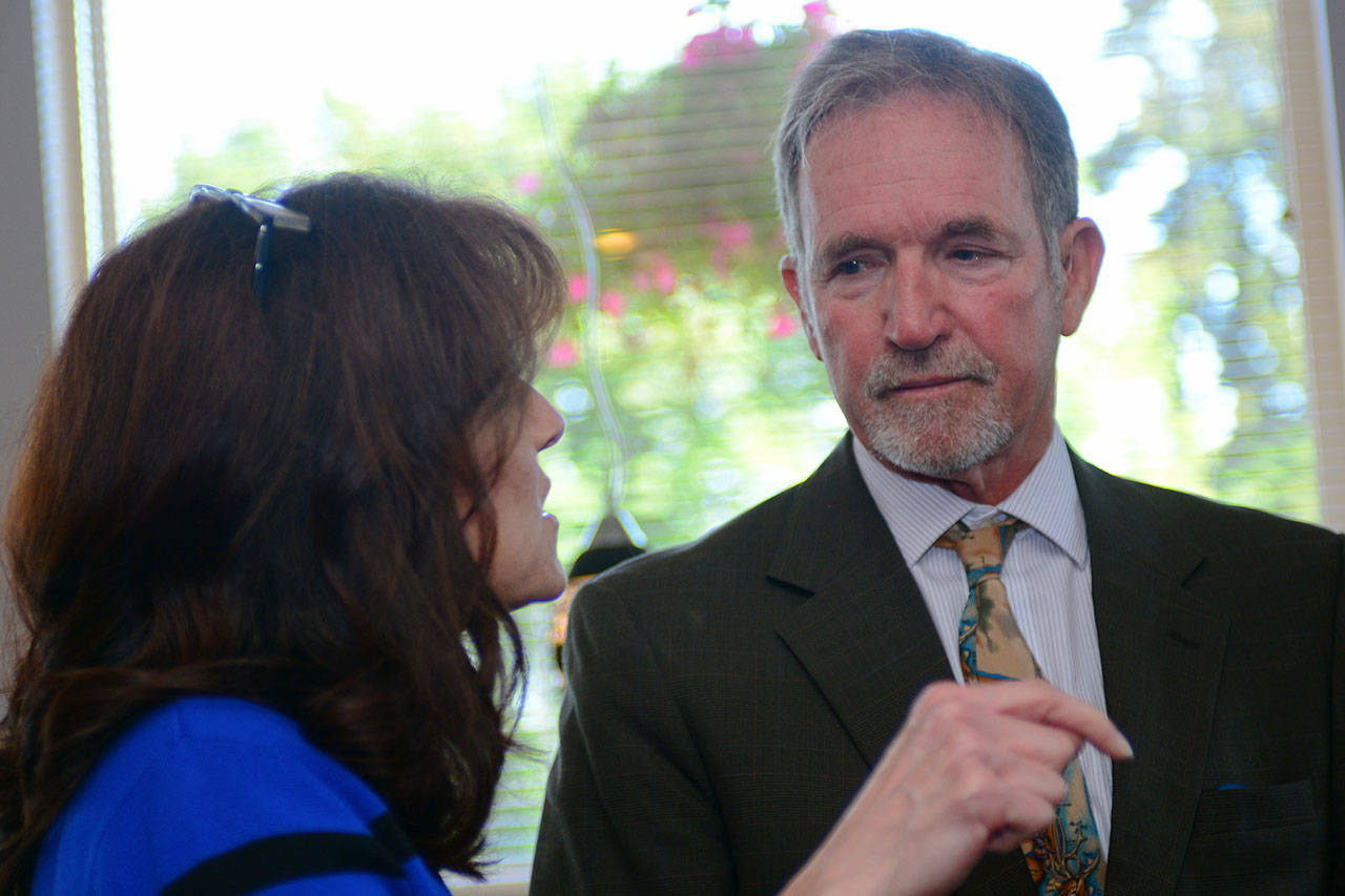 Port of Port Angeles Commissioner Colleen McAleer talks with Port Angeles School District Superintendent Marc Jackson following the Port Angeles Business Association’s meeting Tuesday. Jackson provided details about the likely closure of the North Olympic Peninsula Skills Center in a presentation to PABA. (Jesse Major/Peninsula Daily News)