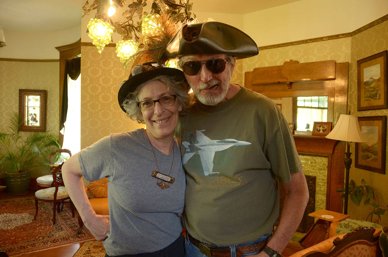 Local steampunkers Jo and Daniel Nieuwsma of Port Townsend prepare downtown for the sixth annual Brass Screw Confederacy Steampunk Festival. (Cydney McFarland/Peninsula Daily News)