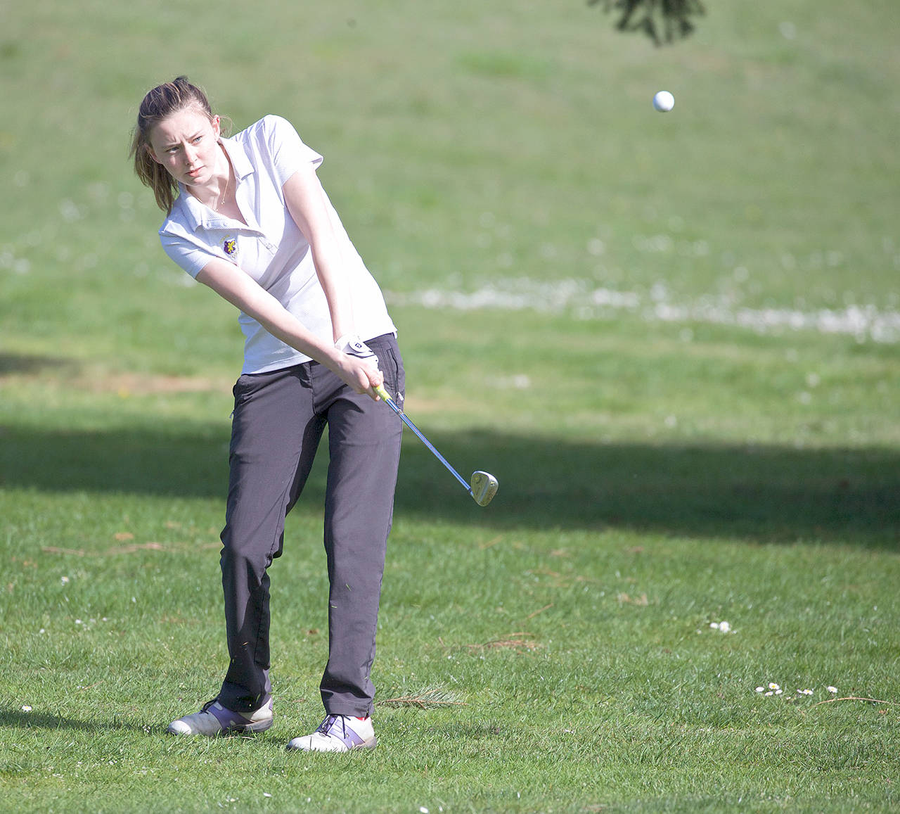 Sequim’s Alex McMenamin chips for the green during a match at Port Townsend Golf Course. McMenamin is the All-Peninsula Girls MVP for the fourth consecutive season.                                Steve Mullensky/for Peninsula Daily News