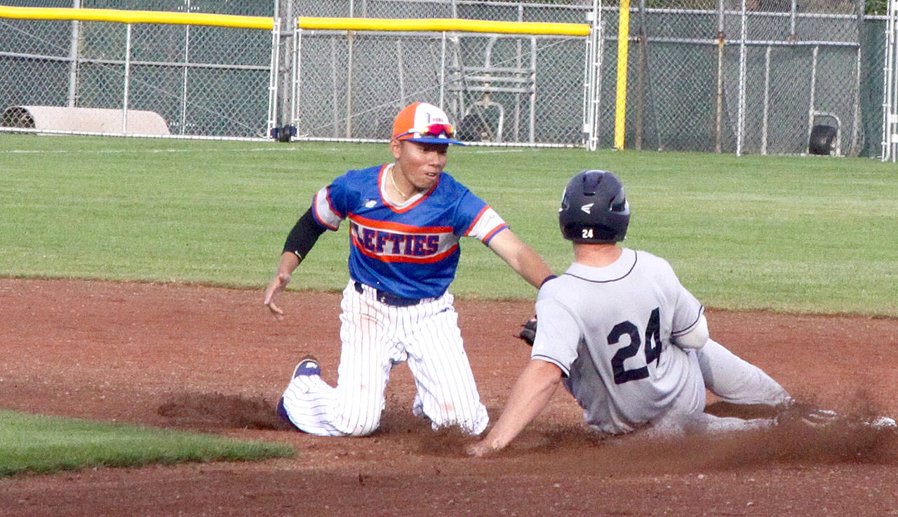 Port Angeles’ Austyn Tengan, left, tags out Walla Walla’s Nick Nyquist on a steal attempt at second base during a game earlier this month. (Dave Logan/for Peninsula Daily News)