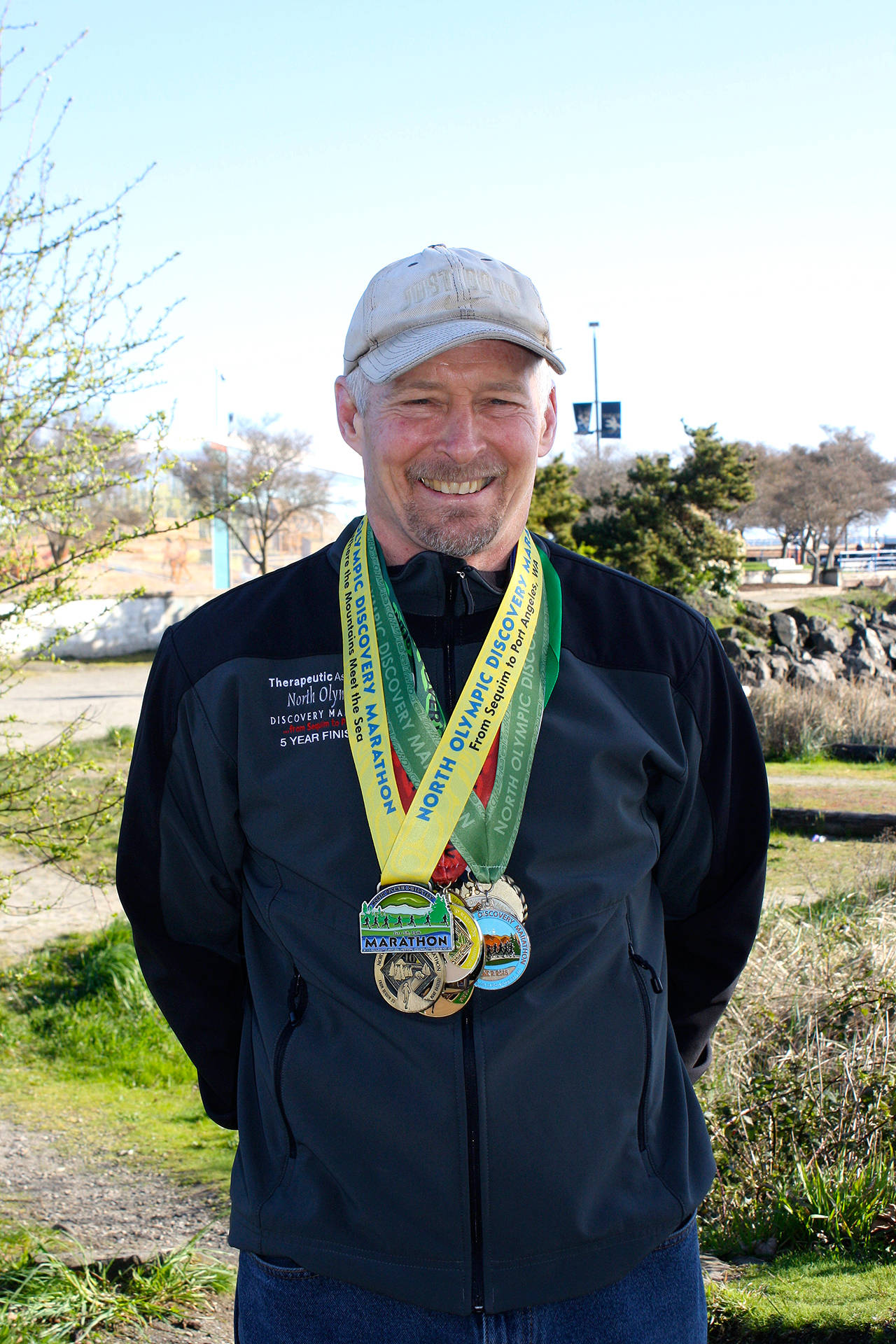 North Olympic Discovery Marathon                                Port Angeles’ Tom Wahl wears his North Olympic Discovery Marathon medals. Wahl has completed all 14 marathons to date, and will run in Sunday’s 15th annual race.