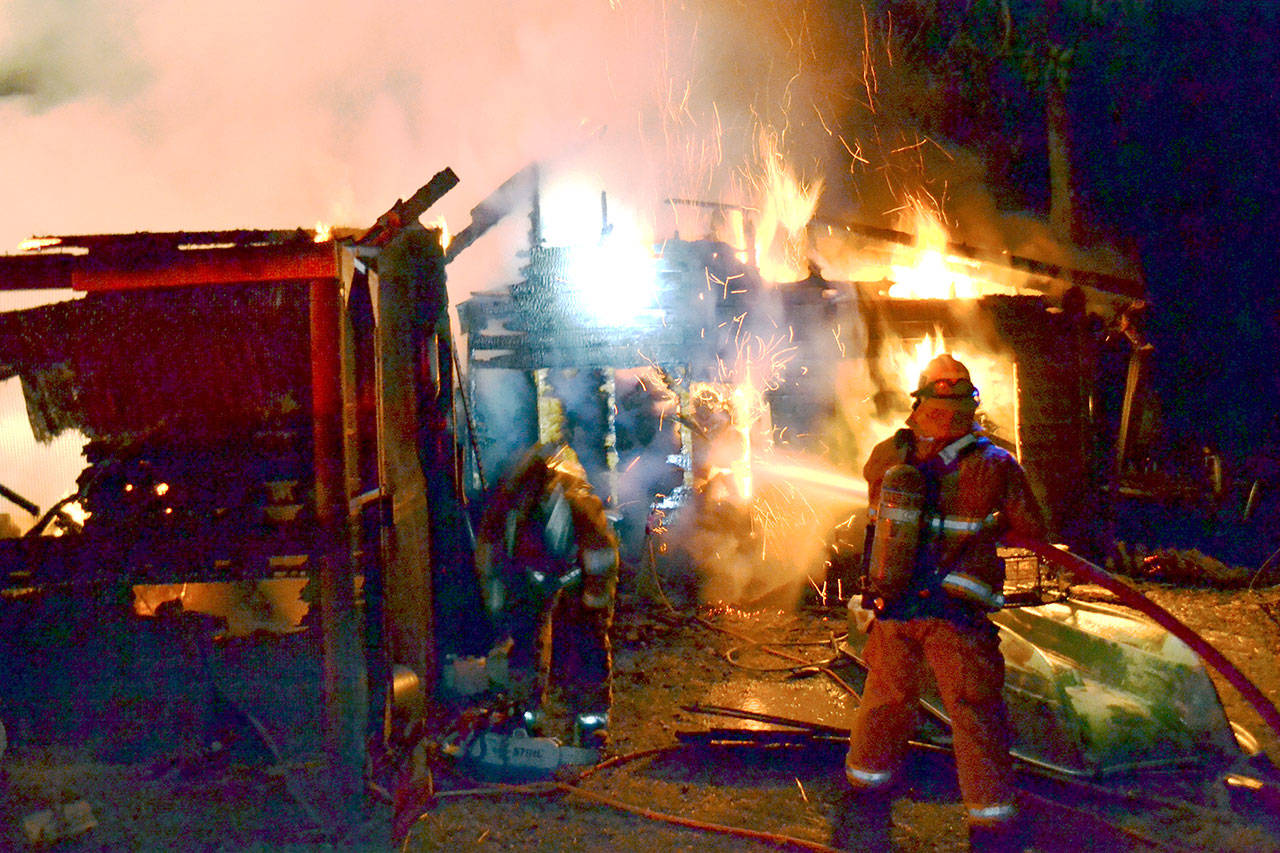 East Jefferson Fire-Rescue firefighters battle against a fire that destroyed a Marrowstone Island barn. (Bill Beezley/East Jefferson Fire-Rescue)