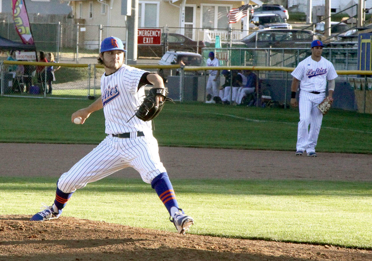 Dave Logan/for the Peninsula Daily News                                Nick Bonniksen of the Lefties pitches to the plate on the Fourth of July as his first baseman Michael Ciancio is ready in the background