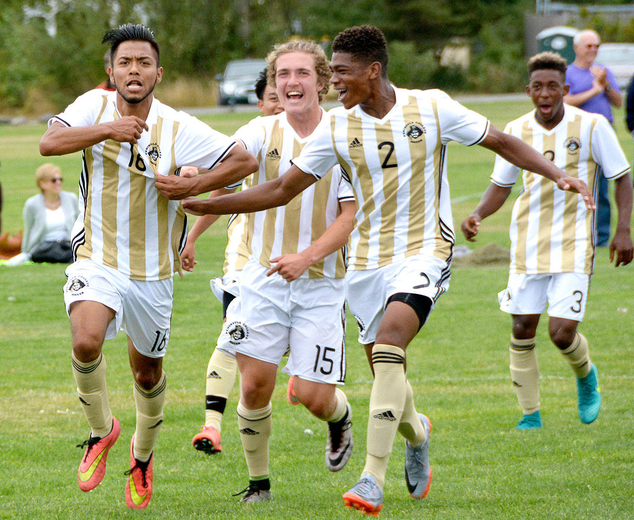 Peninsula sophomore Juan Carrillo-Perez (16) celebrates scoring a goal Friday against Highline with his teammates Peter Jones (15), Sterling Penniston-John (2) and Josia Urquia (3) at Carrie Blake Park in Sequim. (Rick Ross/for Peninsula Daily News)