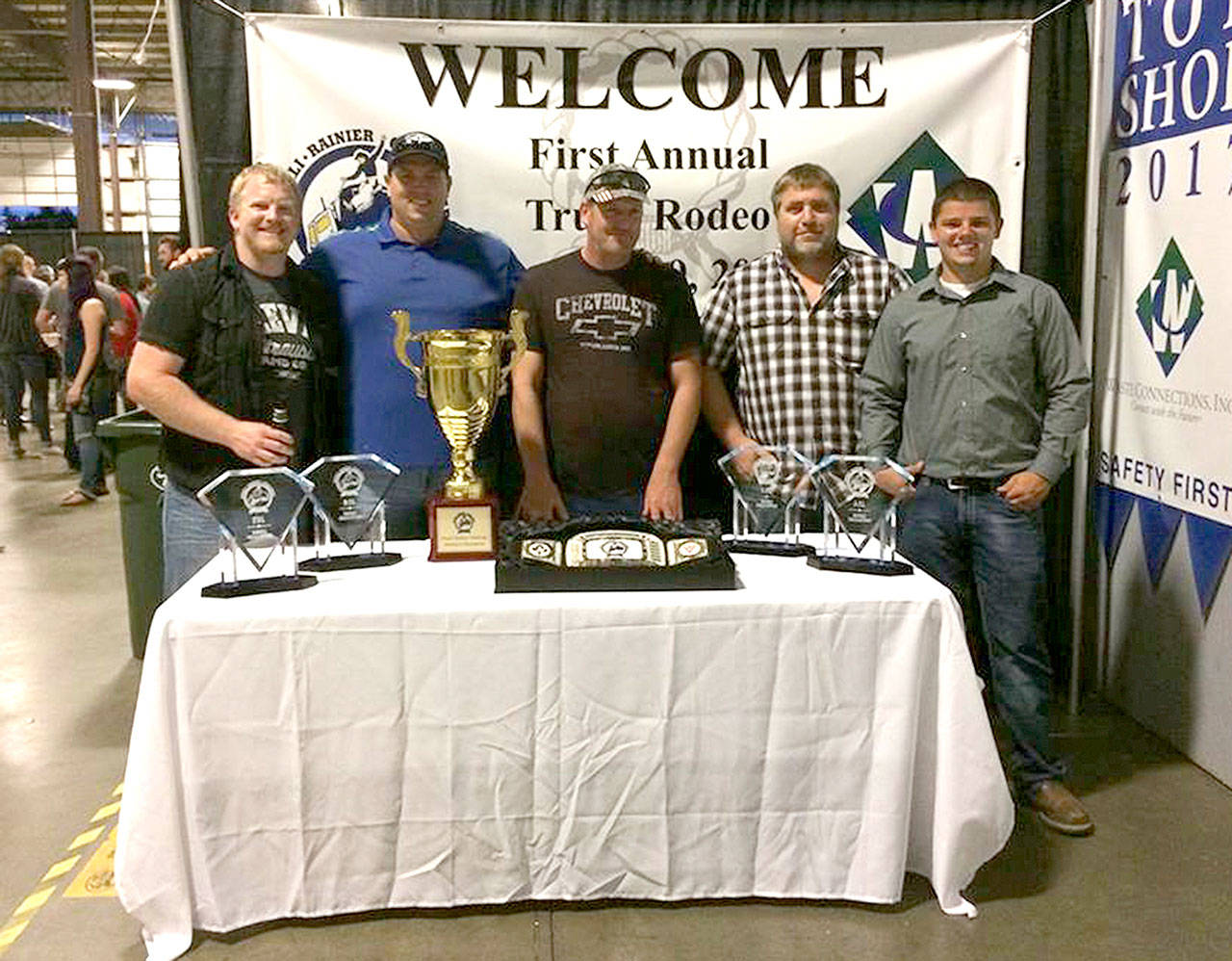 Jeremy Petty of Port Angeles, who drives a rig professionally for Waste Connections in Port Angeles, last week won the Denali Rainier Challenge truck rodeo in Tacoma. Petty beat out 700 other truck drivers to win. He was one of three Waste Connections drivers to compete in the Denali Rainier Challenger. From left are Petty, Chris Giraldes, District Manager and driver Robert Biss, Site Manager Chad Young and driver Joey Deese.