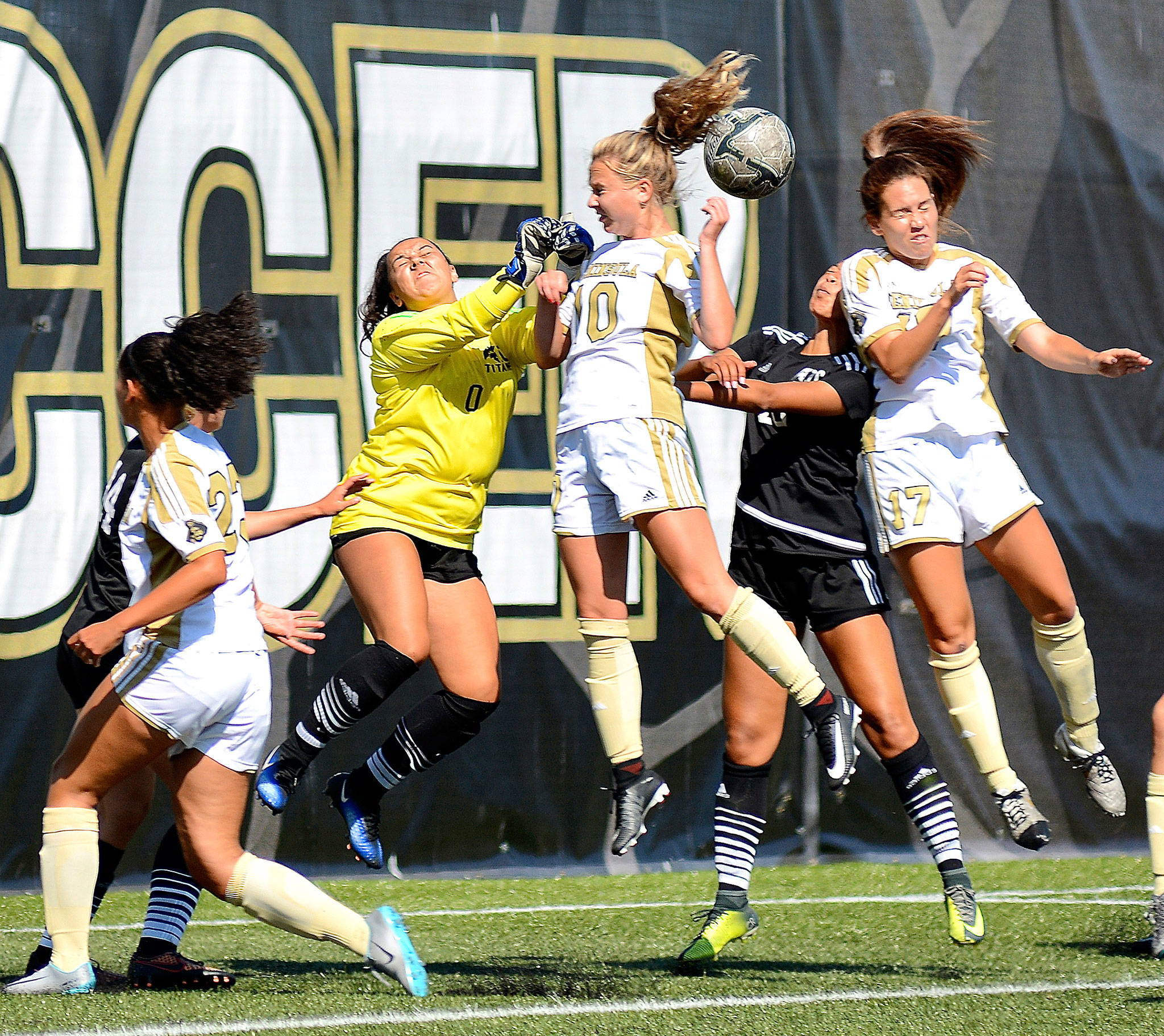 Peninsula’s Kelly Kevershan (10) and Emelie Small (17) battle for a loose ball with Tacoma goalie Courtney Cecil in Tuesday’s 9-0 Peninsula win. In on the play at left is Peninsula’s Halle Watson (23). (Jay Cline/for Peninsula Daily News)