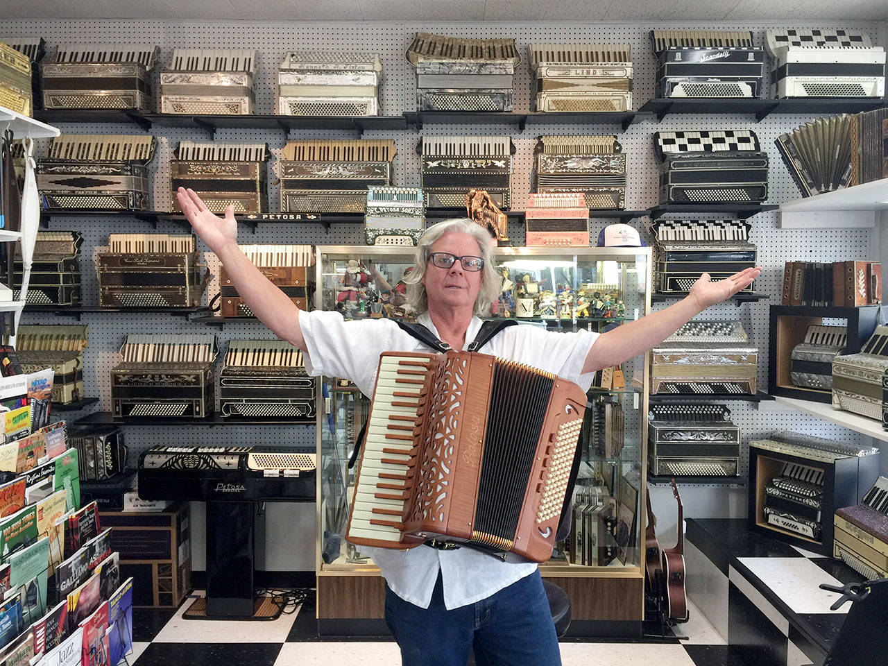 One of the festival organizers Paul Rogers poses in Petosa Accordions, an accordion shop and museum in Seattle. (Paul Rogers)