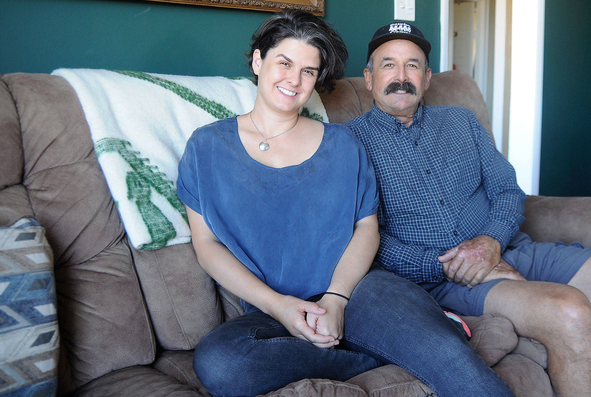 Rachel Mills joins her father, Jerry Pino, in his Sequim home. Mills and Pino met for the first time earlier this year. (Michael Dashiell/Olympic Peninsula News Group)