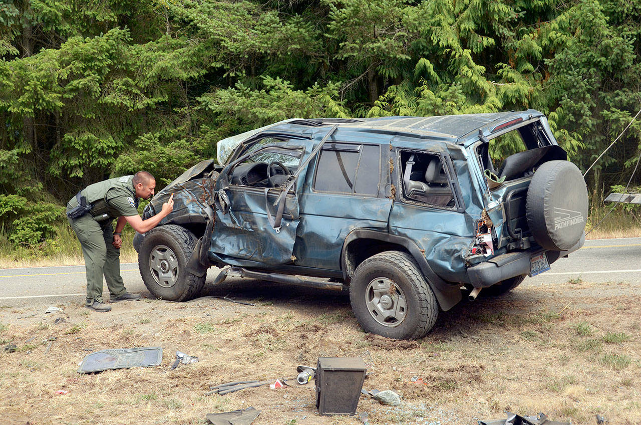 A Port Townsend woman was injured in a rollover wreck Thursday morning. Officials shut down traffic on Cape George Road in both directions while the scene was cleared. (Cydney McFarland/Peninsula Daily News)