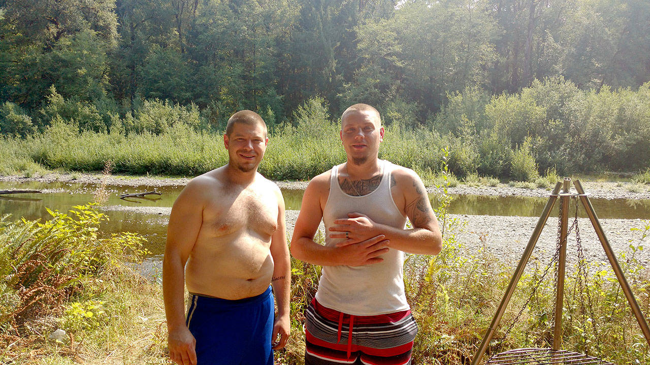 Saxon Teuber and Nick Lipa of Seattle stay cool in the shade of their campsite on the edge of the Calawah River near Forks. (Zorina Barker/for the Peninsula Daily News)