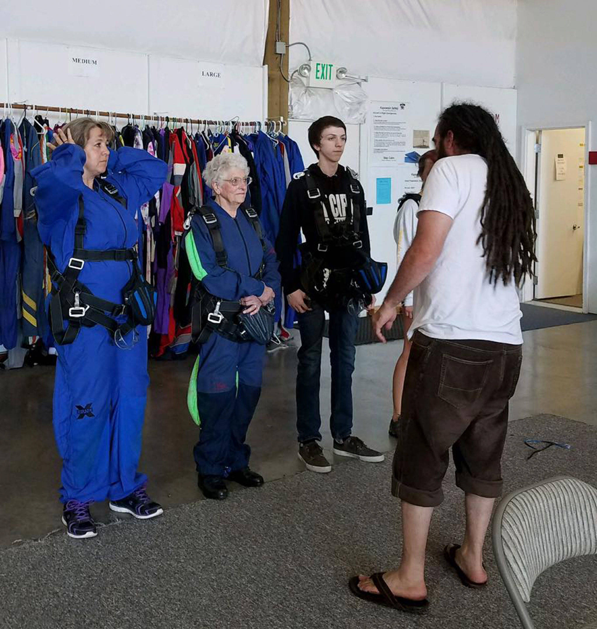 Family members, from left, Darcy Lamb, Clairee Meeks and Connor Lamb listen to an instructor with Skydive Kapowsin in Shelton on Aug. 25. The trio jumped together for the first time that day. It was Meeks’ sixth time. (Clairee Meeks)