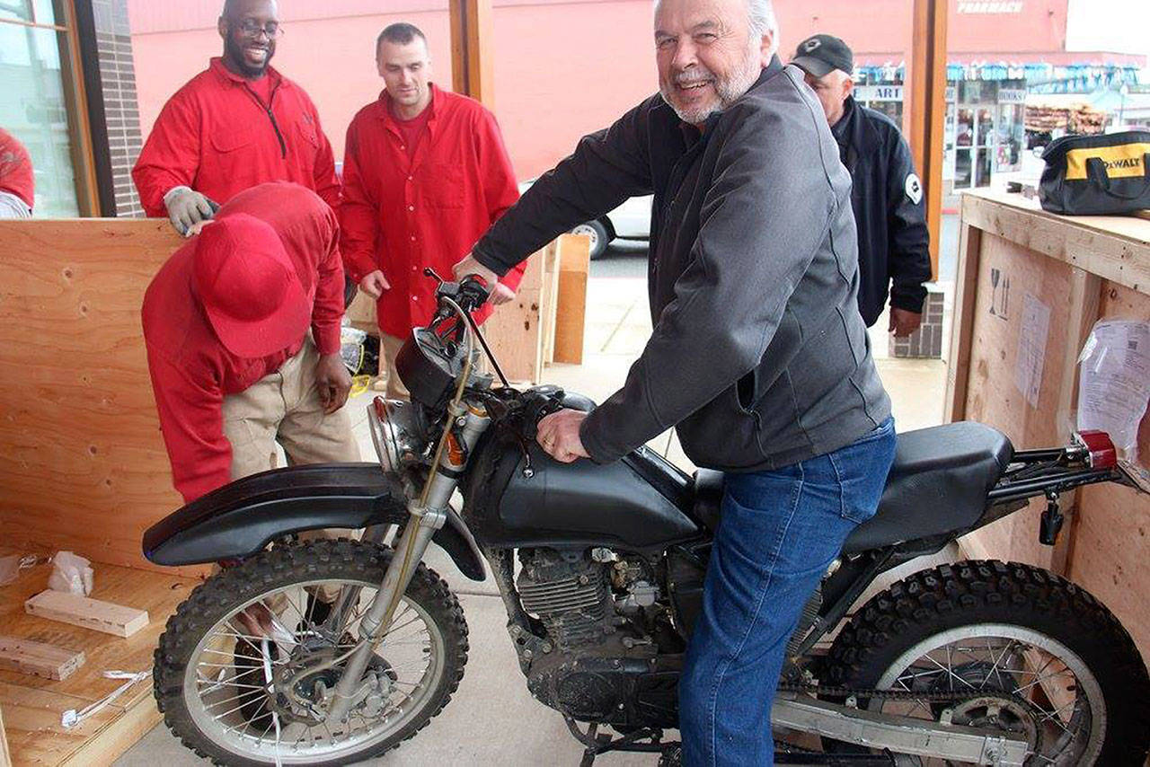 Part of this week’s Twilight festival is the new Forever Twilight in Forks Collection at the Rainforest Arts Center, 35 N. Forks Ave. Forks resident Donald Grafstrom is shown on the motorcycle ridden by character Jacob Black in the movie series when the collection items arrived in Forks this year. (Christi Baron/Olympic Peninsula News Group)