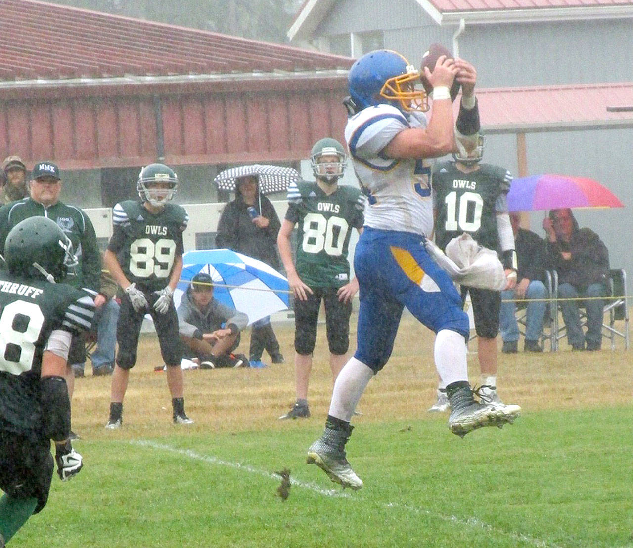 Crescent’s Noah Leonard jumps up to catch a pass against the Mary M. Knight Owls Saturday. Leonard finished the game with 246 yards rushing and 21 yards receiving.