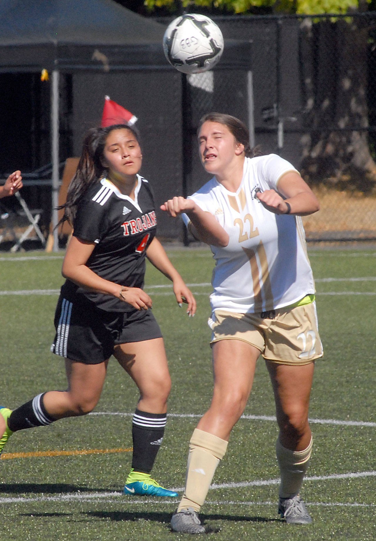 Peninsula’s Samantha Guzman, heads the ball as Everett’s Stephanie Herrera defends during the first half on Wednesday at Wally Sigmar Field in Port Angeles. Keith Thorpe/Peninsula Daily News