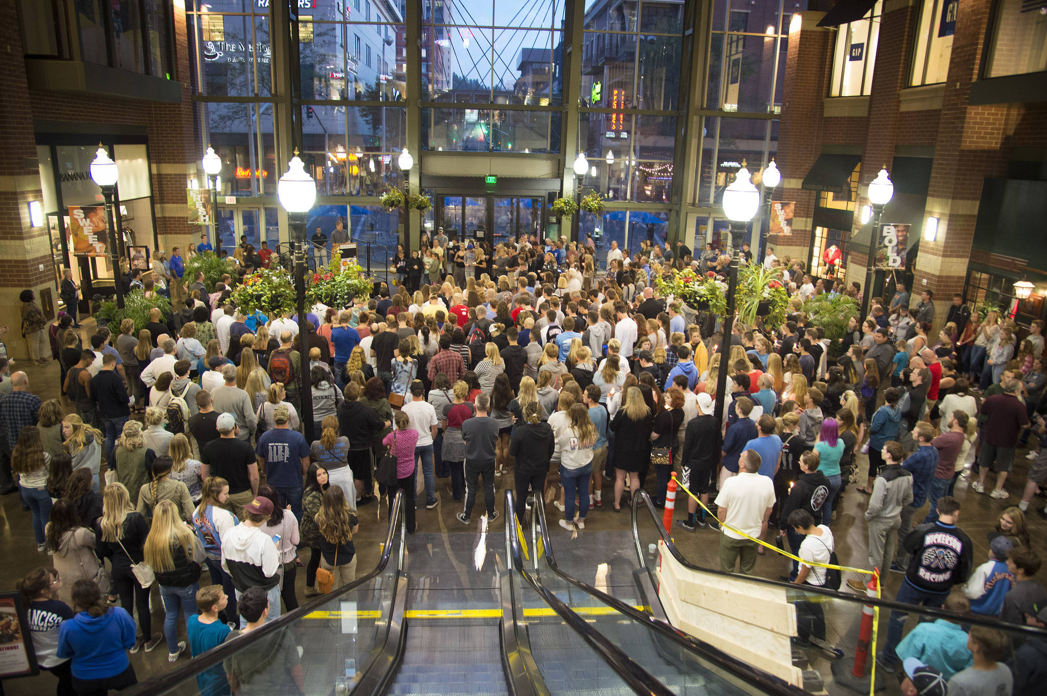 Hundreds gather in the atrium of River Park Square for a candlelight vigil Wednesday in support of the victims of the Freeman High School shooting that occurred earlier in the morning and claimed the life of one student and injured three others. (Colin Mulvany /The Spokesman-Review via AP)