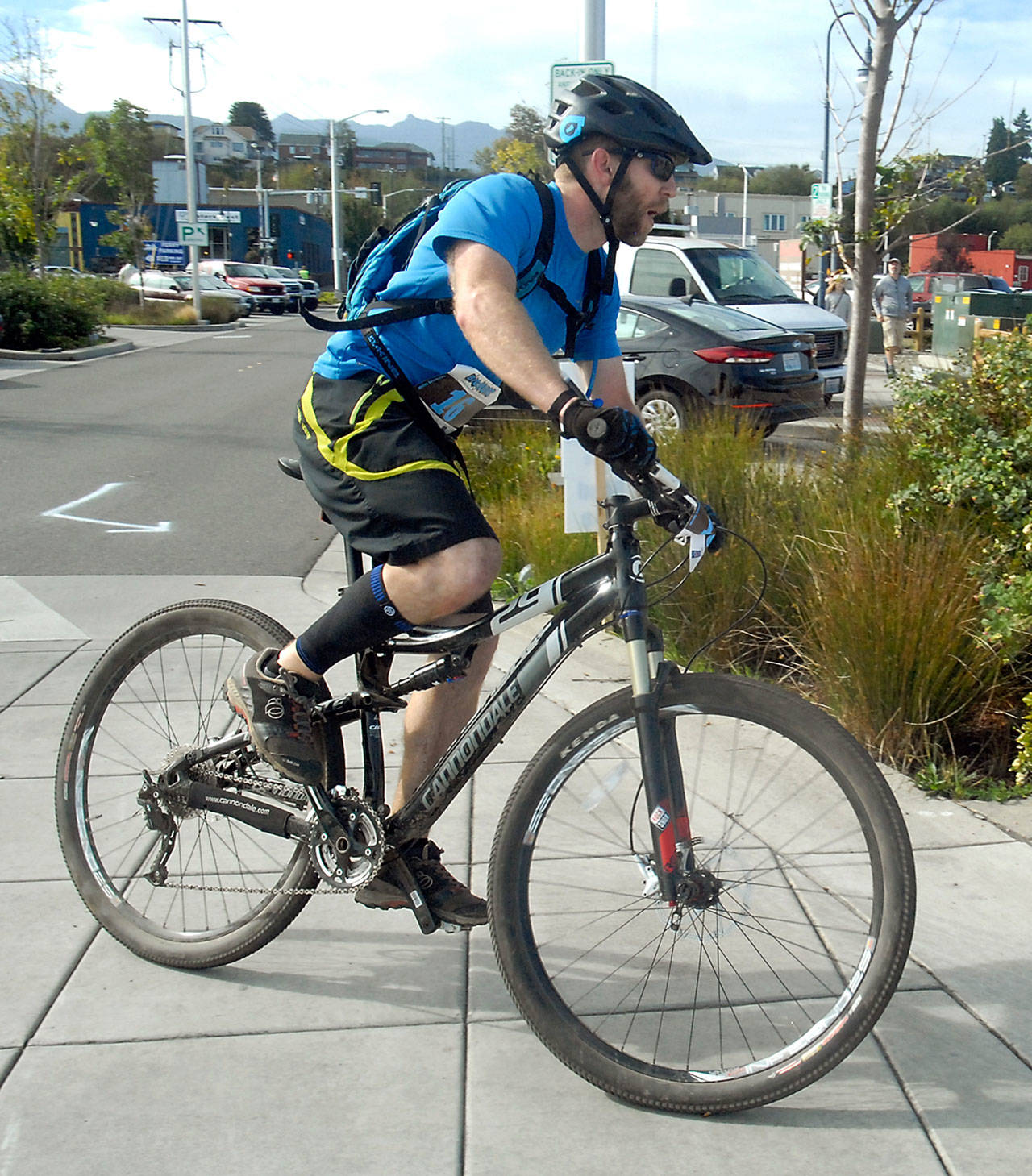 Keith Thorpe/Peninsula Daily News Spencer Larsen of Port Angeles rounds the corner into West End Park, leading in the Iron Man competition after the mountain bike leg of The Big Hurt on Saturday in Port Angeles.