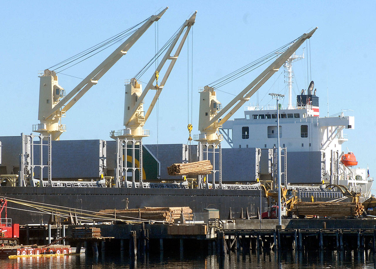 The bulk carrier New Face takes on a cargo of stripped logs at the Port of Port Angeles Terminal 3 on Tuesday in Port Angeles. (Keith Thorpe/Peninsula Daily News)