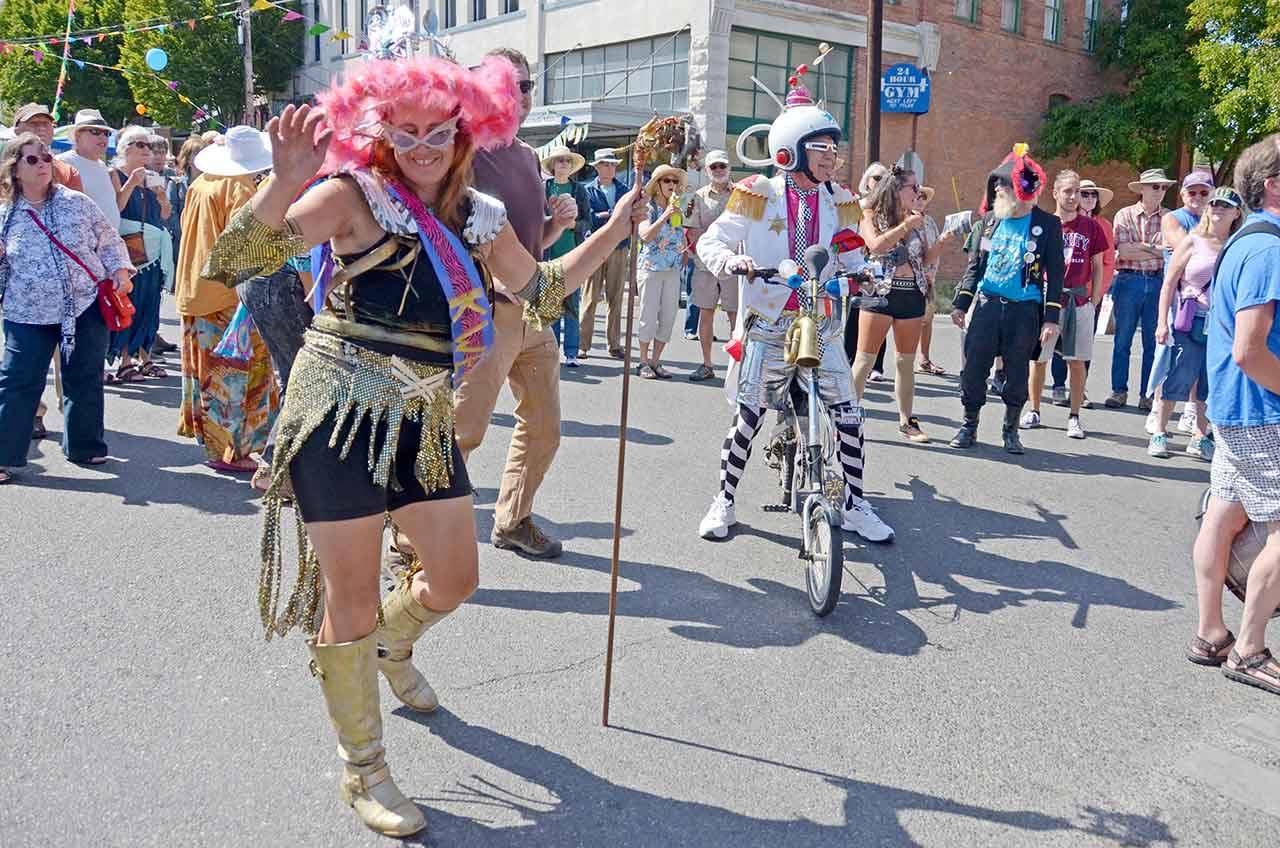 Reigning Kinetic Kween and first year sculpture racer Lisa Doray of Port Townsend dances in the Uptown Street Fair with her team, IPA. (Cydney McFarland/Peninsula Daily News)