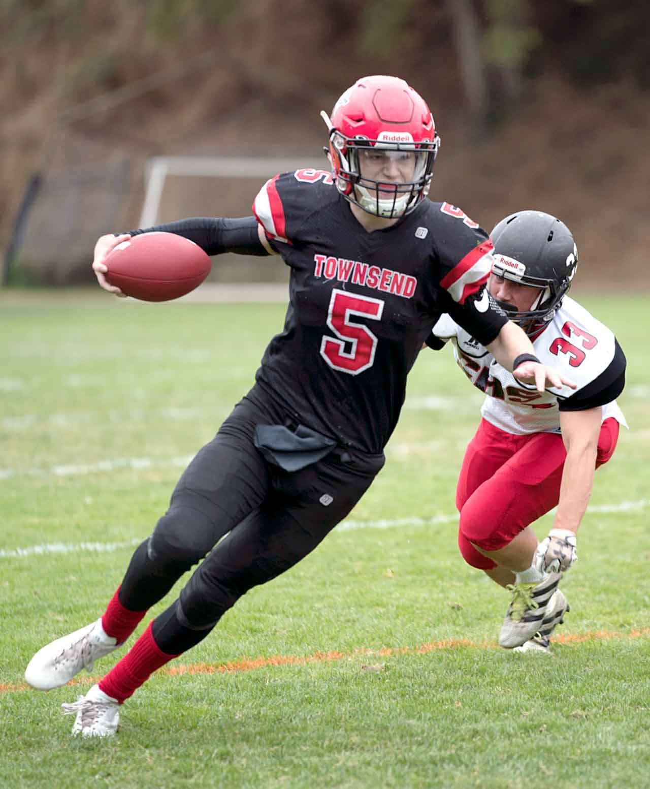 Port Townsend’s Noa Apker-Montoya dodges a tackle by Coupeville’s Teo Keilwitz during a game on Friday in Port Townsend. (Steve Mullensky/for Peninsula Daily News)