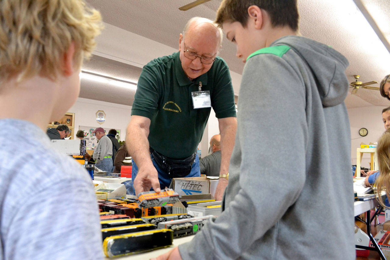 Richard Bell with the North Olympic Peninsula Railroaders speaks with brothers Ben and Jack Clemens of Port Angeles at the club’s annual Trains Show and Swap Meet last year. The show continues this Saturday and Sunday at the Sequim Prairie Grange. (Matthew Nash/Olympic Peninsula News Group)