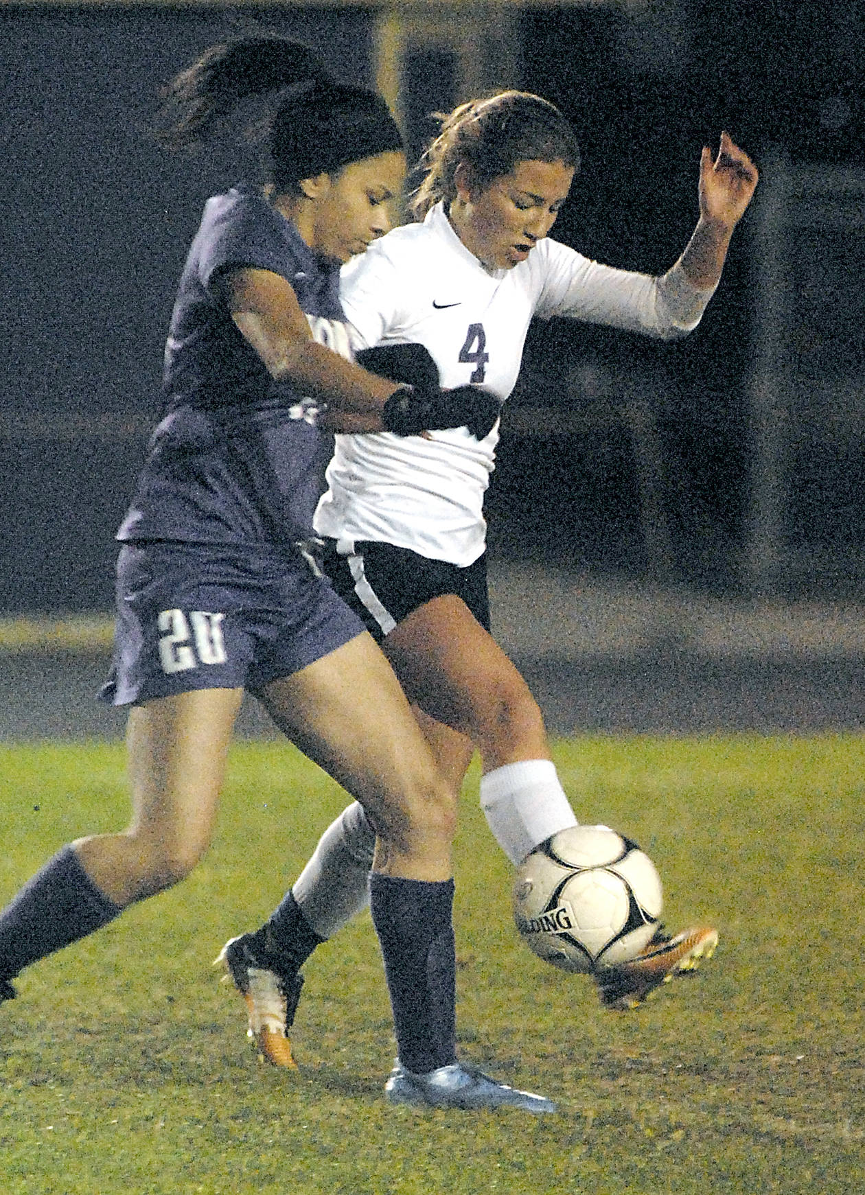 Keith Thorpe/Peninsula Daily News                                Sequim’s Natalya James, right, slips the ball past North Kitsap’s Isla Lester during the Wolves’ 1-0 loss.