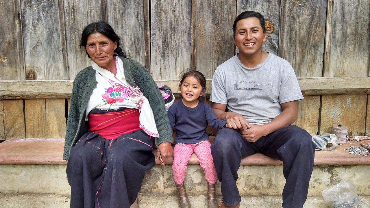 Three generations of a Maya family pose for a photograph. Mujeres de Maíz Opportunity Foundation sponsors a children’s program in their community. (Judith Pasco)