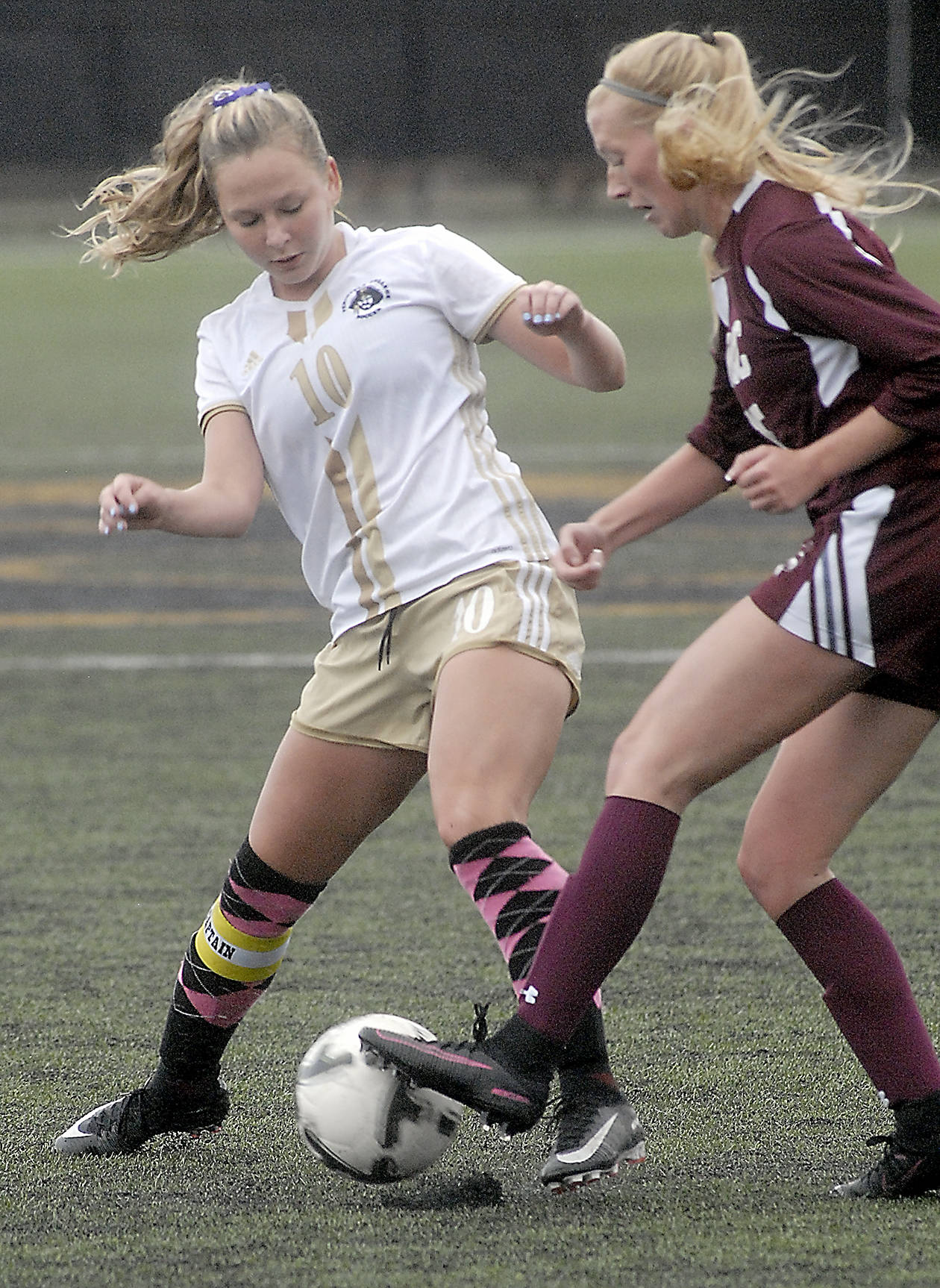 Keith Thorpe/Peninsula Daily News                                Peninsula’s Kelly Kevershan, left, battles for the ball with Whatcom’s Payton Lunde on Wednesday at Wally Sigmar Field.