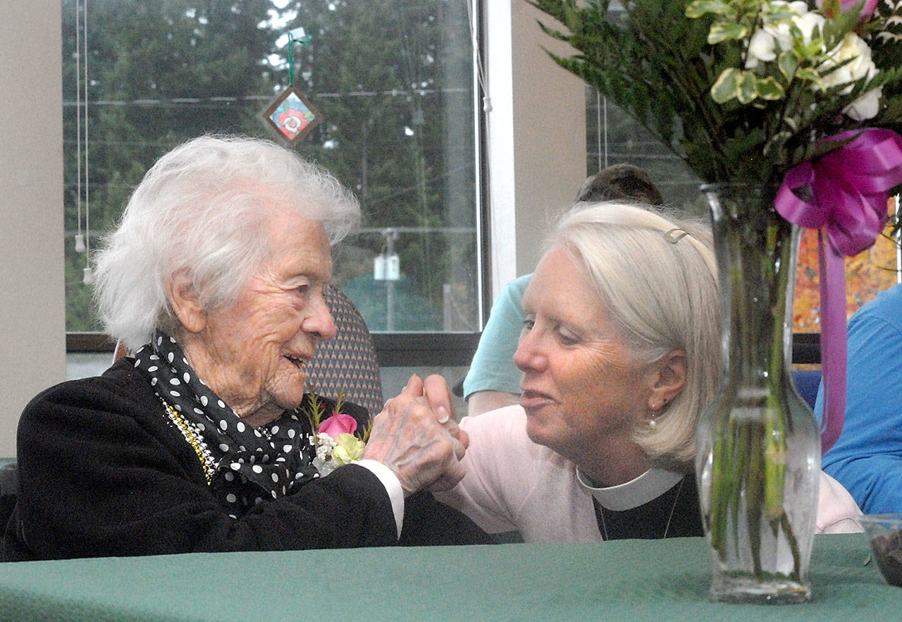 Dorothy Waters, a resident of Crestwood Health and Rehabilitation Center in Port Angeles, shares a moment with her friend the Rev. Gail Wheatley of St. Andrew’s Episcopal Church during Waters’ 107th birthday celebration at the center. (Keith Thorpe/Peninsula Daily News)