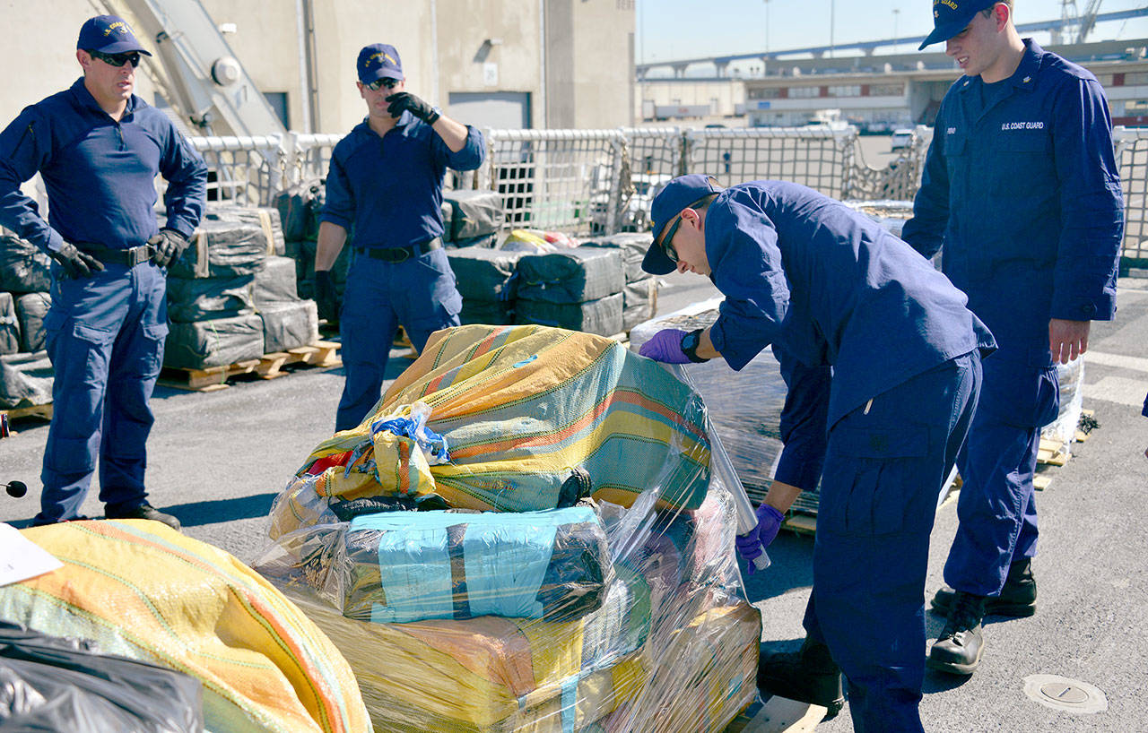 The crew of the Coast Guard cutter Active wraps pallets of cocaine in San Diego, Calif., during a drug offload Wednesday. (Taylor Bacon/U.S. Coast Guard)