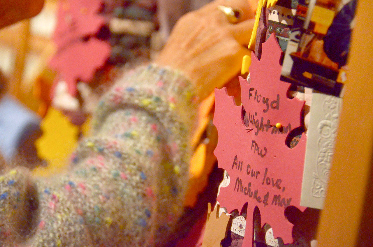 Community members pinned names and mementos of loved ones who died in the last year to a memory quilt that will be displayed at the Hospice Offices at Jefferson Healthcare for the next year. (Cydney McFarland/Peninsula Daily News)