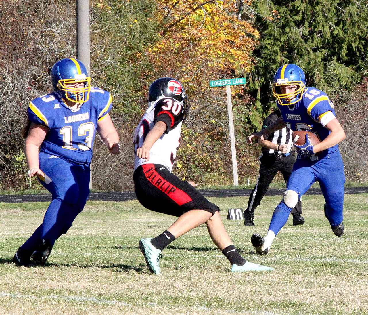 Crescent quarterback K.C. Spencer tries to elude Jeremiah Armajo-Diaz of Tulalip Heritage. Raine Westfall (13) is in on the play blocking. (Dave Logan/for Peninsula Daily News)