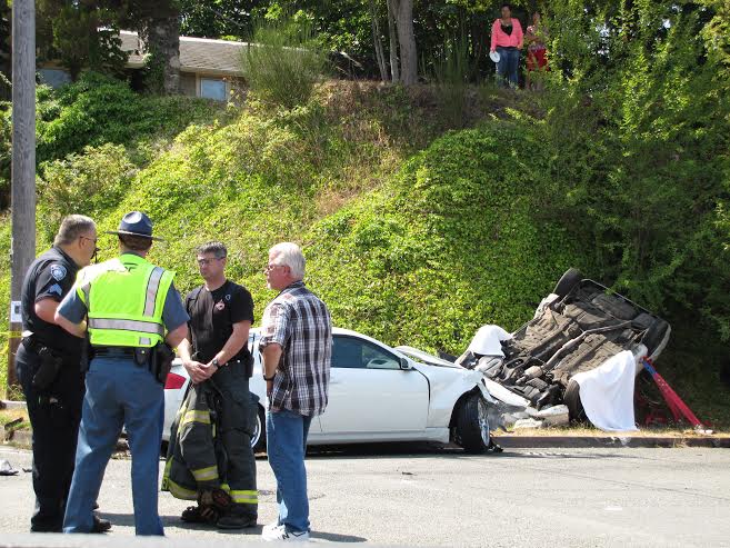 Port Angeles Police Sgt. Glen Roggenbuck talks with State Patrol and Port Angeles Fire Department representatives at the scene of a fatal wreck at East Eighth and  South Washington streets in Port Angeles. Arwyn Rice/Peninsula Daily News