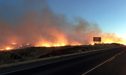 This photo provided by the Washington state Department of Transportation shows fire burning along State Route 14 near Roosevelt