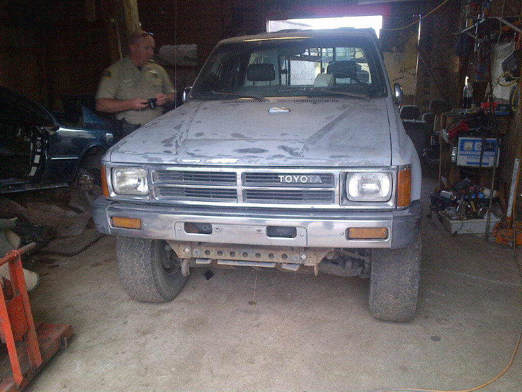 Clallam County Sheriff's Detective Shaun Minks looks over a 1988 Toyota pickup truck reported stolen from the Port Angeles area that was found in a barn east of Port Angeles on Saturday. Sgt. Randy Pieper/ClallamCounty Sheriff's Office