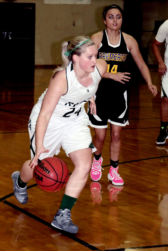 Port Angeles' Hayley Baxley drives toward to the basket ahead of Bremerton's Alyssa Beach (14). (Dave Logan/for Peninsula Daily News)